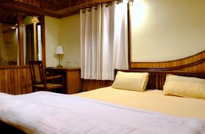 Posteľ alebo postele v izbe v ubytovaní Shantiniketan Mountain Home