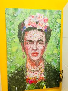 a painting of a woman with flowers on her head at ConteMax ArtHouse in Salerno