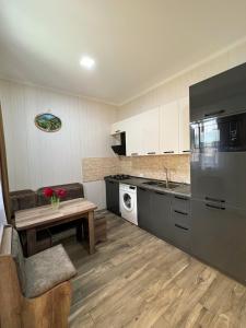 a kitchen with a refrigerator and a table in it at Royal Galaxy in Stepantsminda