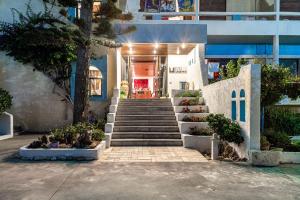 a stairway leading to a building with blue and white at Hotel Tsagarakis Beach in Amoudara Herakliou