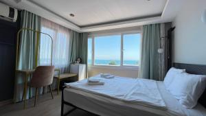 Postel nebo postele na pokoji v ubytování Ora Bella Hotel