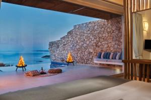a bedroom with a view of the ocean at Emerald Villas & Suites - The Finest Hotels Of The World in Agios Nikolaos