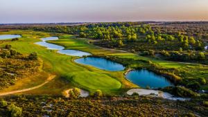 an aerial view of a golf course with two lakes at Posia Retreat & Spa UNA Esperienze in San Foca