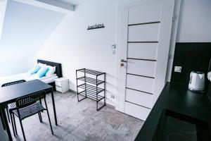 a small room with a desk and a bed at Apart Bałtyk Pokoje & Apartamenty in Łeba