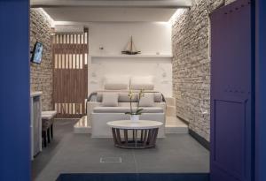 a living room with a couch and a table at The Colourful Land Syrma in Klima