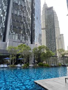 a large swimming pool in front of tall buildings at Star Residence KLCC By FZB in Kuala Lumpur