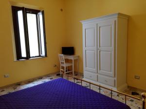 a bedroom with a purple bed and a window at La Fragola Viola in Perugia