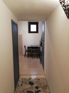 a hallway with a table and a dining room at La Fragola Viola in Perugia