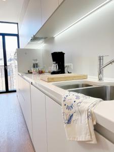 a kitchen with white cabinets and a sink and a sink at Jacob’s Getaway in Ghent