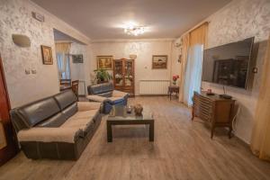 a living room with a couch and a table at Villa MontAnja in Herceg-Novi