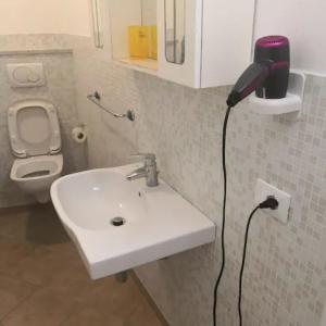 a bathroom with a sink and a hair dryer on the wall at affittacamere nuova Vandiris in Manarola