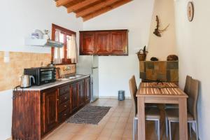 a kitchen with a small table and a microwave at F & B Summer Collection- Skiathos -Maistrali in Skiathos