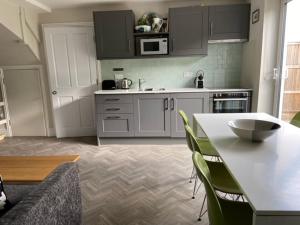 a kitchen with a table and chairs in a kitchen at The Studio in Worthing