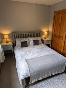 a bedroom with a large bed with two night stands at Holiday Accommodation Perth Scotland - Oakview in Perth