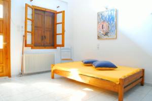 a bedroom with a bed with blue pillows on it at Studios Efi in Kala Nera