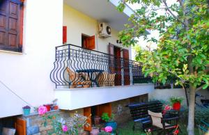 a balcony with a couch sitting on it at Studios Efi in Kala Nera