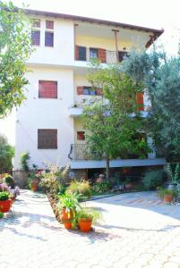 a building with plants in front of it at Studios Efi in Kala Nera