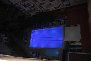 a large blue screen on a wall in a room at Max Nova Hotel in Alanya