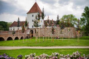 a castle with christmas trees in front of a wall at A12 Home Sárvár in Sárvár