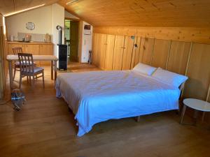 a bedroom with a bed and a table and a kitchen at Watzmann in Bischofswiesen