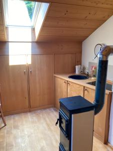 a kitchen with a stove with a window in it at Watzmann in Bischofswiesen