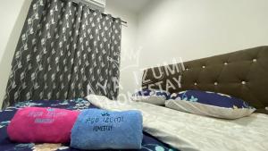 a bedroom with a bed with a black headboard and pillows at Aya Izumi 3 bed Condo near to Bangi Wonderland in Kajang +27 photos