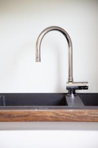 a kitchen sink with a stainless steel faucet at Villa Umberto in San Giovanni in Marignano
