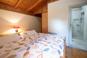 a bedroom with a bed and a glass shower at Idyllic Holiday House For Two in Rukavac