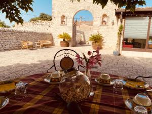 a table with plates of food on top at Mastro Vanni - Urban Masseria in Ragusa