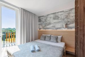 a bedroom with a bed and a large window at Domaine de Miremer in La Garde-Freinet