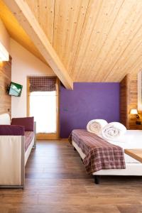 a bedroom with a bed and a window at Green Rose in Livigno