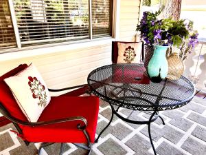 a patio with two chairs and a table and a vase with flowers at Hidden Gem Retreat in the Heart of Payson in Payson