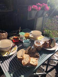 a picnic table with bread and other foods on it at Le Pika in Hauteluce