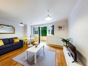 a living room with a couch and a table at Redhill town centre apartment by Livingo in Redhill