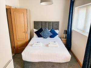 a bedroom with a bed and a dresser at Broc House Suites in Dublin