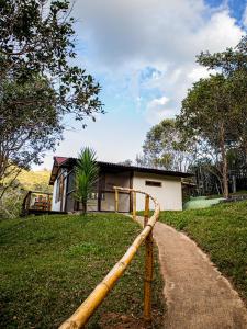 a path leading to a house with a building at Vila Cosmica in Lagoinha