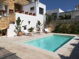 a swimming pool in the yard of a house at Dimora Maltese in Morciano di Leuca