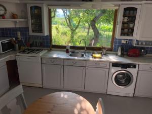 a kitchen with a sink and a washing machine at Home on Iznik Lake with its own Private Beach in Bursa