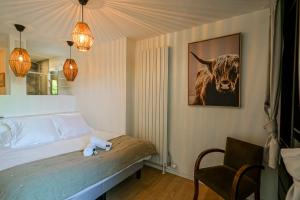 a bedroom with a bed with a picture of a cow at Le Poisson Vert apartment 6 people 200m from the beach of Sevrier! in Sévrier