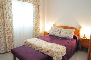 Ένα ή περισσότερα κρεβάτια σε δωμάτιο στο EmyCanarias Holiday Homes Vecindario