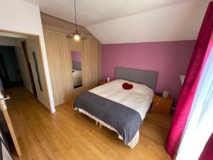 a bedroom with a bed with a red heart on it at Maison Hotel proche Paris et Orly in Athis-Mons