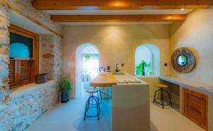 a kitchen with a counter and stools in a room at Churchill Townhouse in Bodrum City