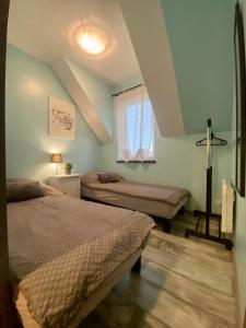 a bedroom with two beds and a window at APARTAMENT FAMILIJNY KRYNICA MORSKA - 10 osób 2 poziomy 2 łazienki kuchnia in Krynica Morska