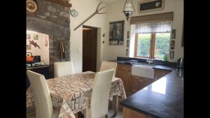 a kitchen and dining room with a table and chairs at Traditional Stone lodge, Llandeilo in Llandeilo