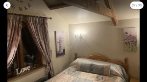 a bedroom with a bed with a wooden head board at Traditional Stone lodge, Llandeilo in Llandeilo