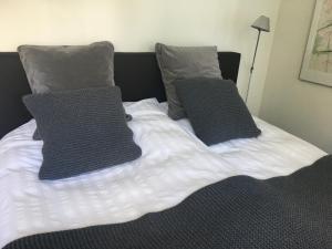 a bed with two pillows on top of it at Retour de Provence in Almelo