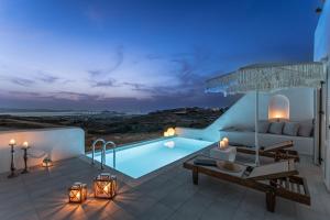 a villa with a swimming pool at night at Ariadne's Crown Luxury AstroConcept Suites with Private Pools and Spas in Vívlos