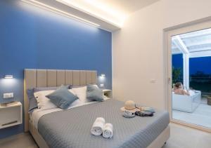 a bedroom with a large bed with towels on it at Coppa Carrubo Residenza in Vieste