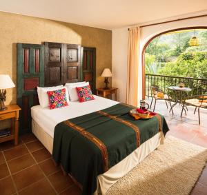 a bedroom with a bed and a balcony at Villa Santa Catarina in Panajachel