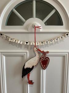 a bird on a door with a heart on it at Houssen/Colmar: « Chez Lin’Doux », le Nid Alsacien in Houssen